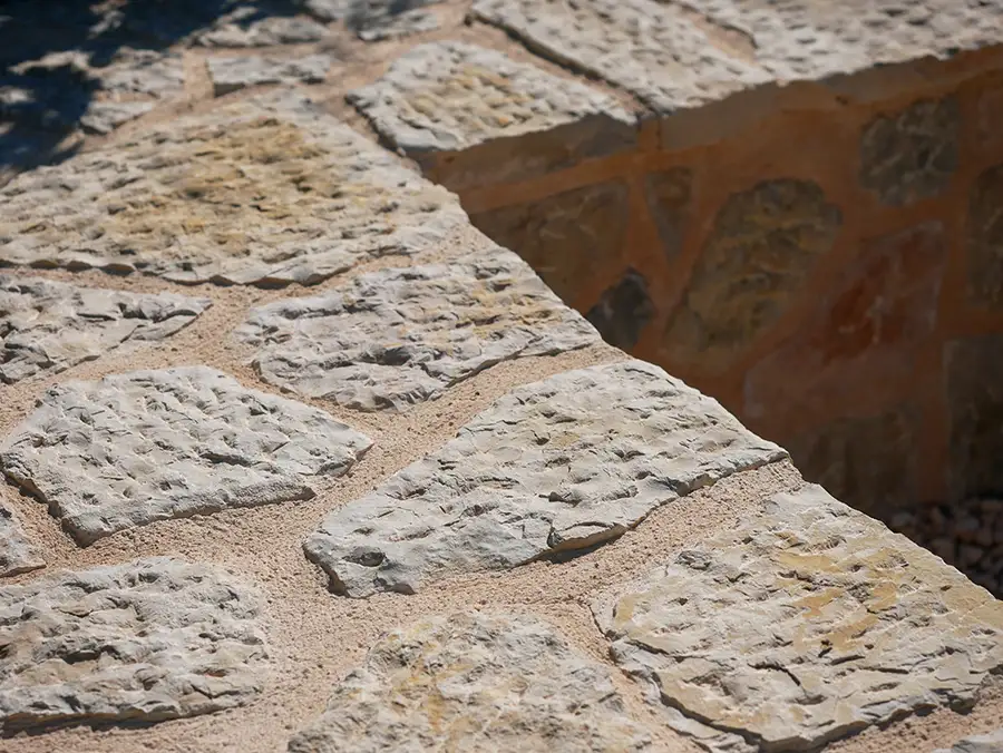 Textured Mallorcan stone wall corner with jointed limestone blocks.