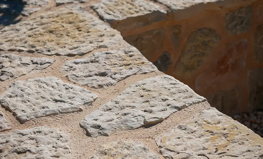 Close-up of dry-laid Mallorcan stone wall with rustic limestone blocks and sand-filled joints